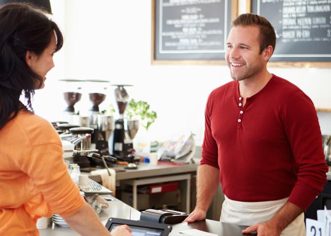 kind business worker and customer exchange greeting