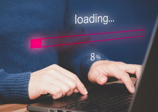 website loading graphic with person on laptop