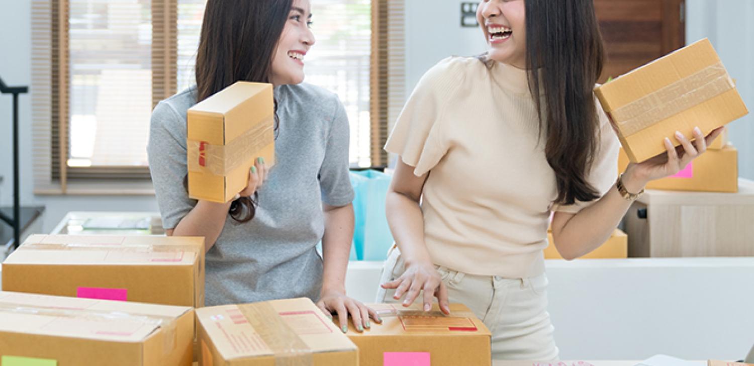 Two entrepreneurs share a laugh as they work.