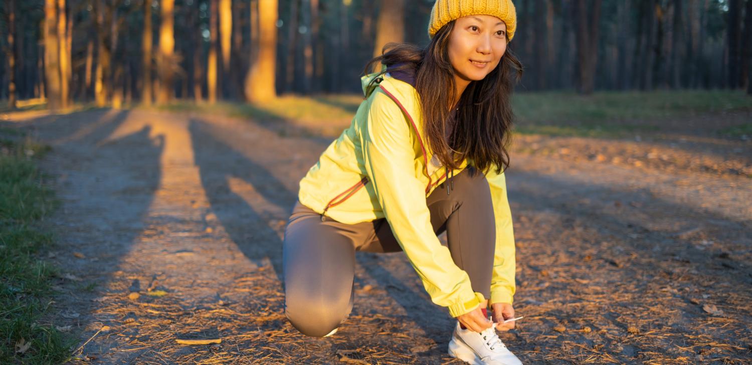 Female runner tying shoe