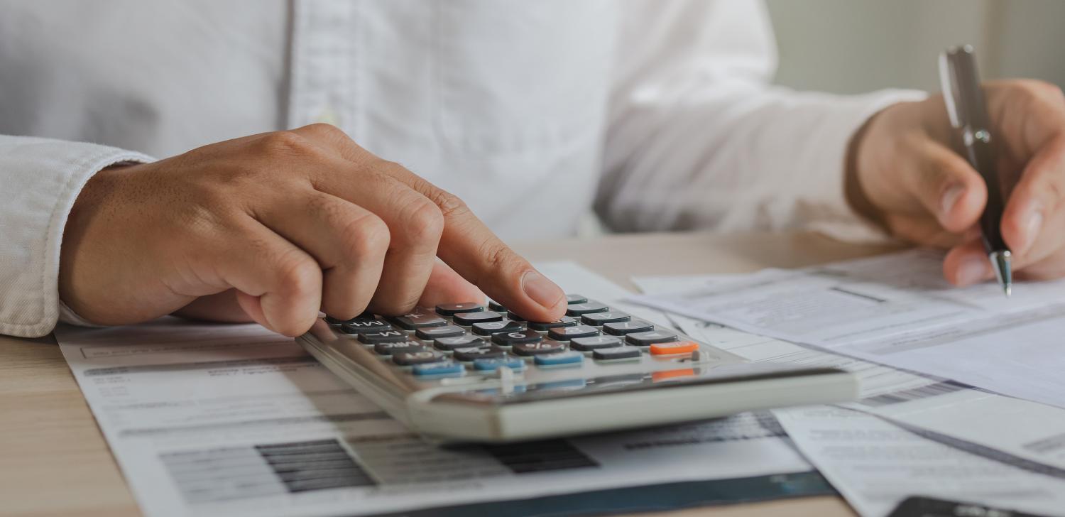 Business person with calculator and paper 