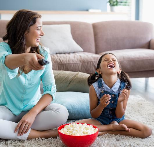 Mother and Daughter Watching TV and Laughing Thumbnail